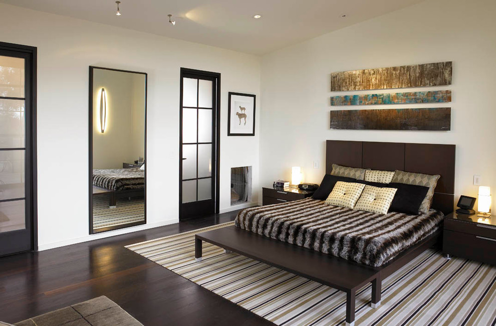 Photo of a contemporary bedroom in San Diego with white walls and dark hardwood floors.