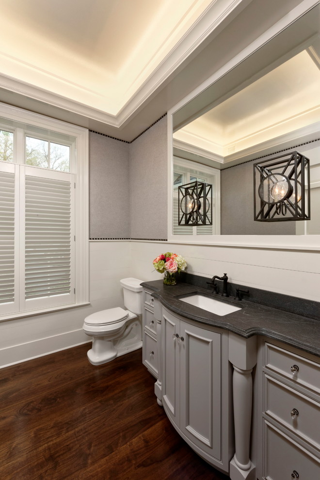 Photo of an expansive traditional bathroom in DC Metro with beaded inset cabinets, grey cabinets, a one-piece toilet, mosaic tile, multi-coloured walls, marble floors, an undermount sink, soapstone benchtops and white floor.