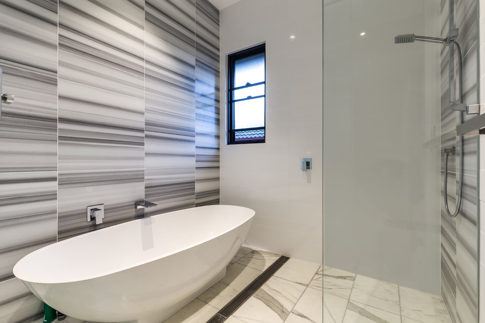 Mid-sized modern kids bathroom in Brisbane with beaded inset cabinets, beige cabinets, a freestanding tub, an open shower, a one-piece toilet, multi-coloured tile, marble, multi-coloured walls, marble floors, a drop-in sink, marble benchtops, beige floor and an open shower.
