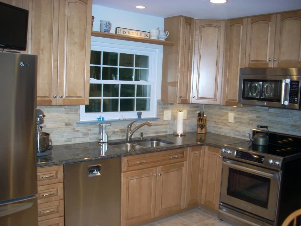 Kitchen - small galley ceramic tile kitchen idea in DC Metro with brown cabinets, granite countertops, ceramic backsplash and stainless steel appliances