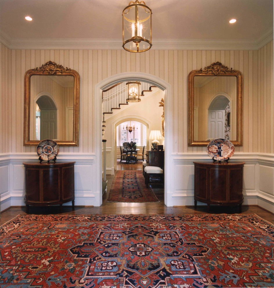 Photo of a mid-sized traditional foyer in Charlotte with beige walls and medium hardwood floors.