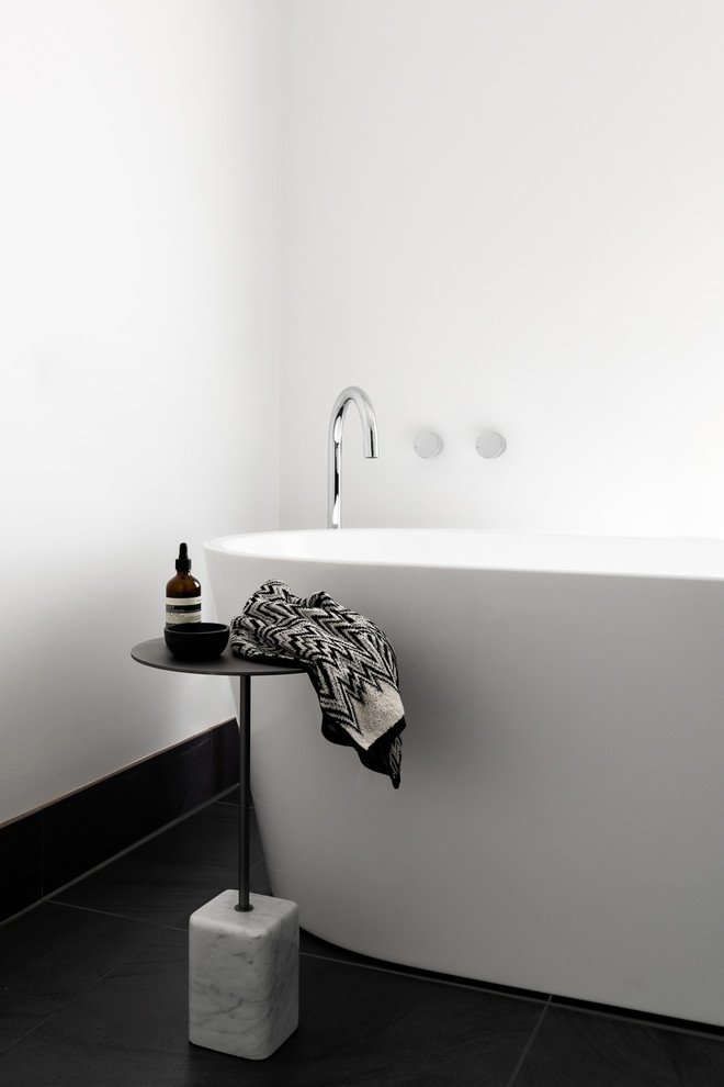 Large contemporary master wet room bathroom in Melbourne with flat-panel cabinets, black cabinets, a freestanding tub, a one-piece toilet, gray tile, ceramic tile, white walls, ceramic floors, an undermount sink, marble benchtops, grey floor, a hinged shower door and multi-coloured benchtops.