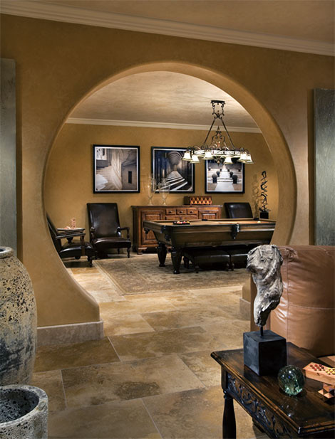 Design ideas for a mid-sized mediterranean enclosed family room in Phoenix with beige walls and travertine floors.