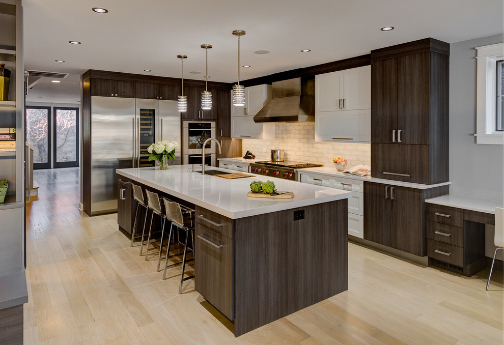 Inspiration for a contemporary l-shaped kitchen in Chicago with an undermount sink, flat-panel cabinets, dark wood cabinets, white splashback, stainless steel appliances, light hardwood floors and with island.