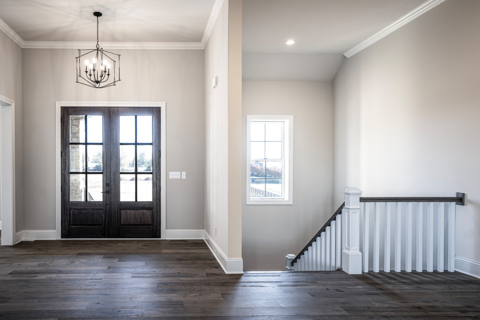 Example of a large transitional vinyl floor and brown floor foyer design with gray walls and a dark wood front door