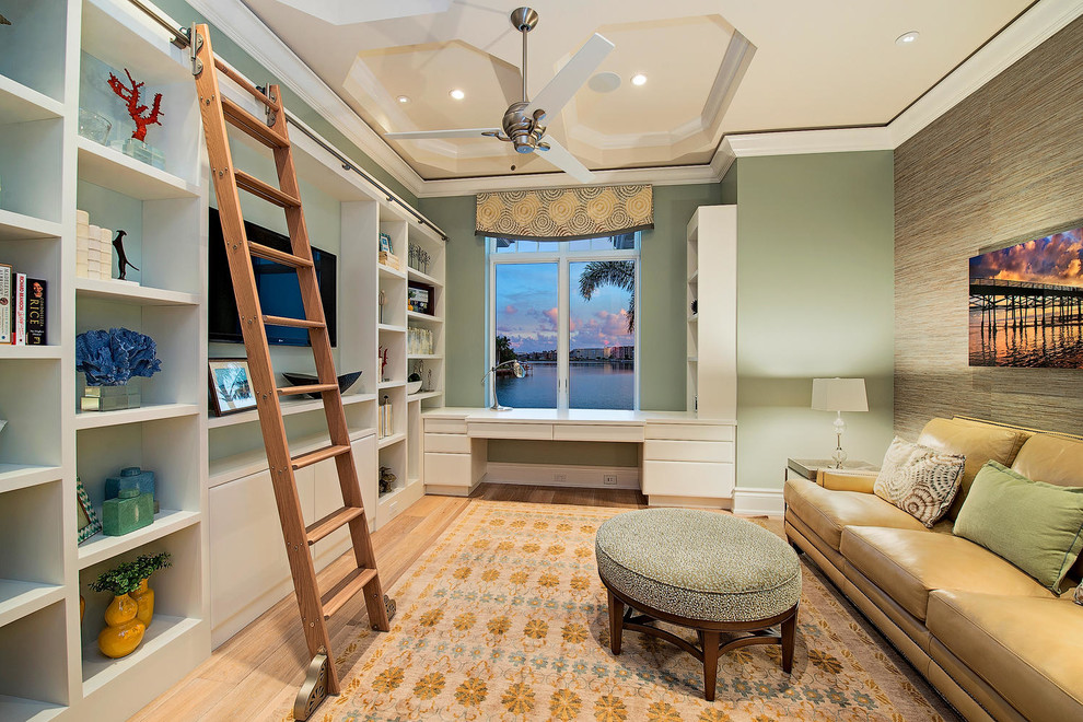Example of a mid-sized transitional built-in desk and enclosed medium tone wood floor and beige floor living room design in Miami with green walls, no fireplace and a wall-mounted tv