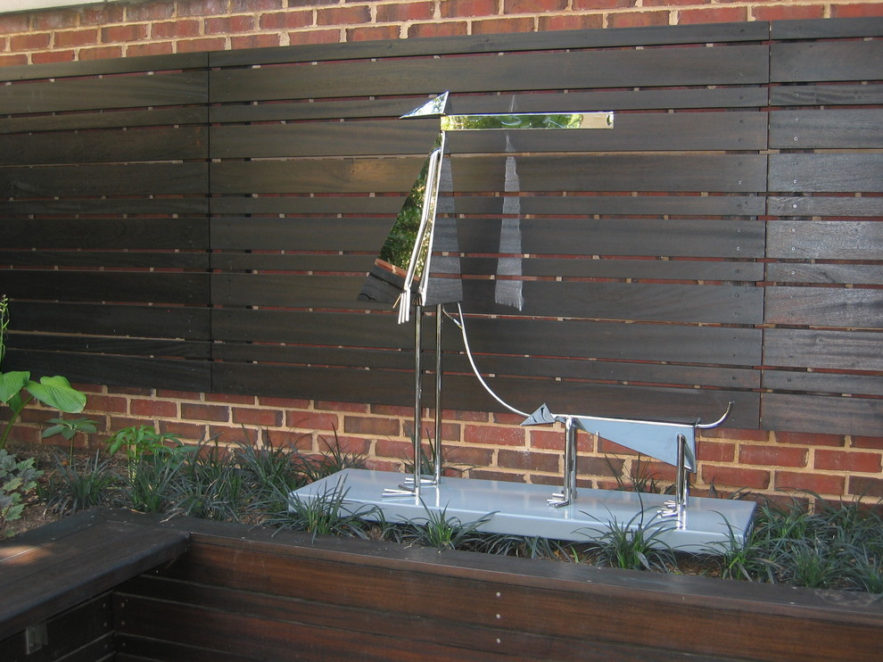 Small trendy backyard stone patio photo in DC Metro with no cover