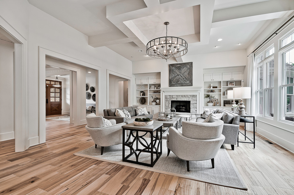 Photo of a large arts and crafts formal open concept living room in Little Rock with white walls, light hardwood floors, a standard fireplace and a stone fireplace surround.