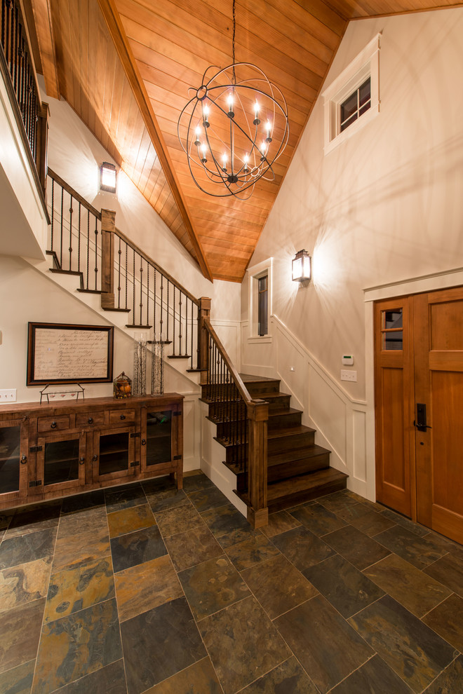 Mid-sized country wood l-shaped staircase in Burlington with wood risers and mixed railing.