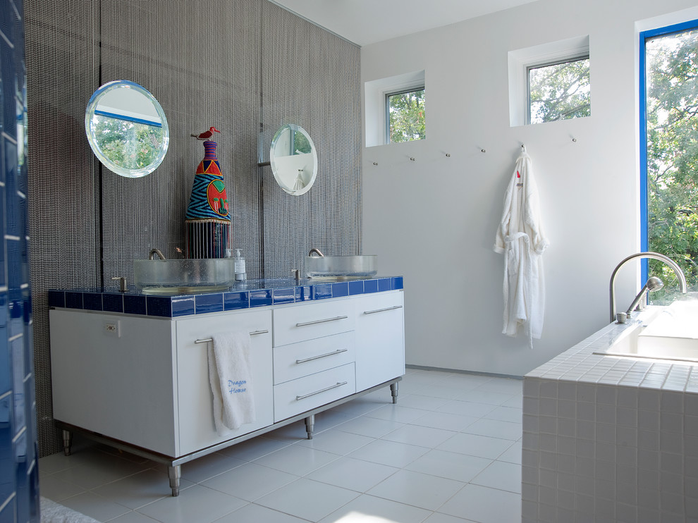 Inspiration for an eclectic bathroom in Dallas with white cabinets, tile benchtops and blue benchtops.
