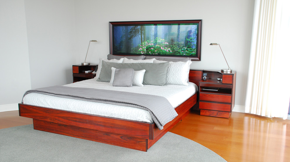 Bedroom - large contemporary master medium tone wood floor bedroom idea in Atlanta with gray walls