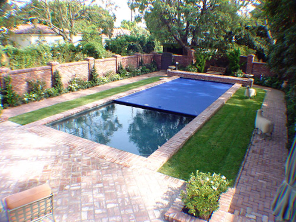 Inspiration for a large brick and rectangular pool remodel in Miami