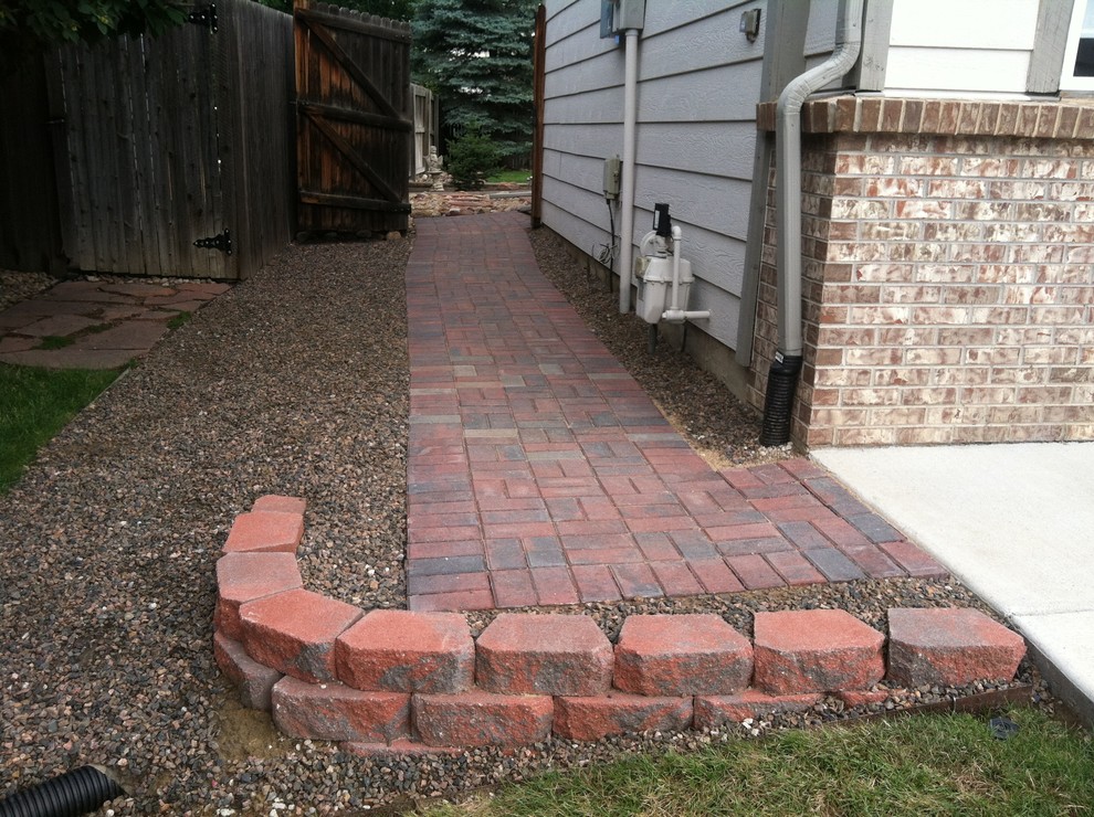 This is an example of a mid-sized contemporary side yard shaded garden in Denver with a garden path and brick pavers.