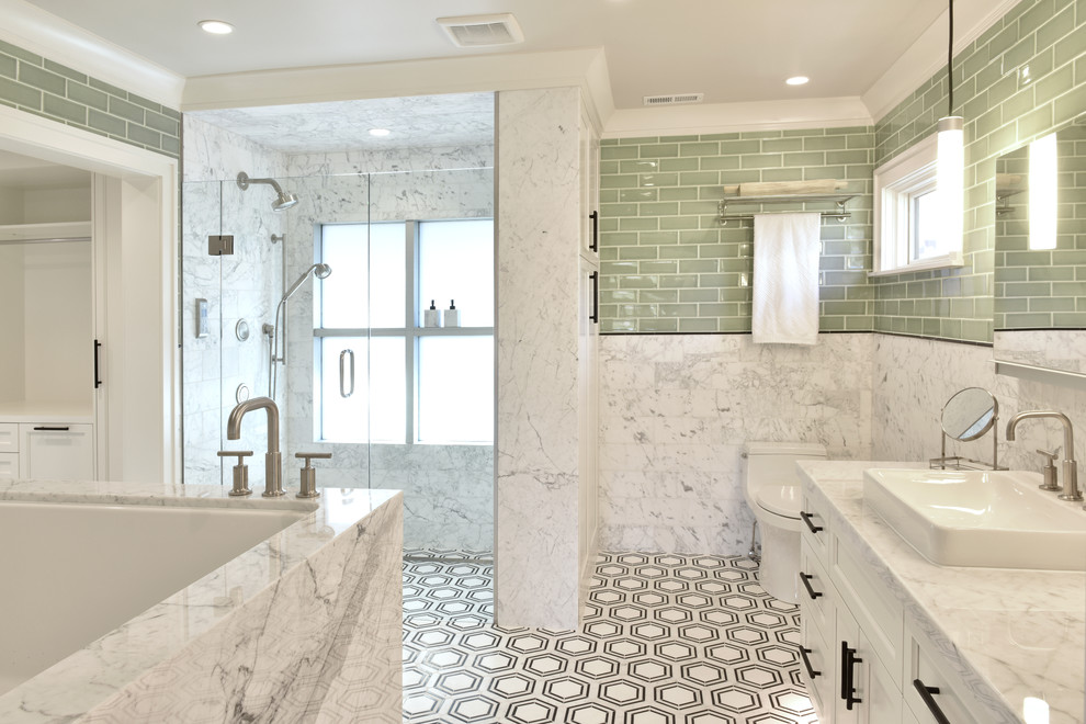 This is an example of a transitional master bathroom in Other with white cabinets, a corner tub, a curbless shower, a one-piece toilet, green tile, ceramic tile, marble floors, a vessel sink, marble benchtops, a hinged shower door, white benchtops, recessed-panel cabinets and multi-coloured floor.
