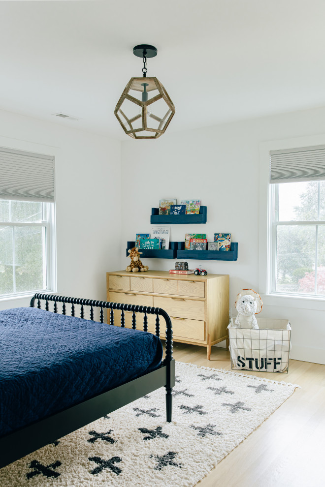 Example of a large beach style guest light wood floor, brown floor and shiplap wall bedroom design in Other with blue walls and no fireplace
