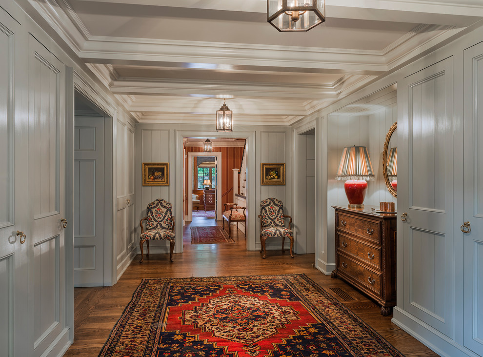This is an example of a traditional hallway in Philadelphia with grey walls and dark hardwood floors.