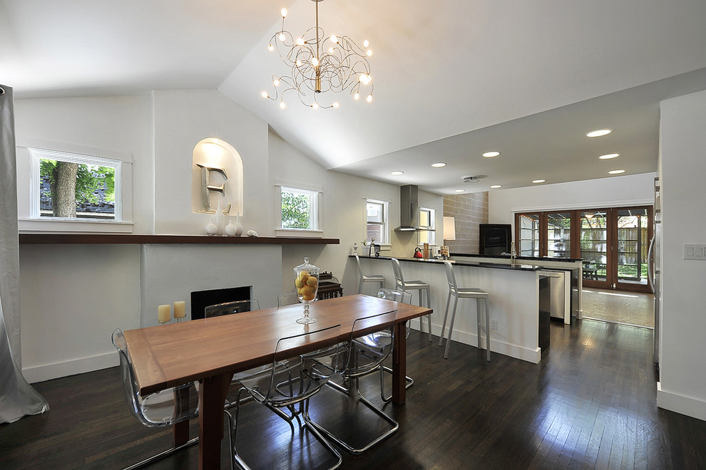 Transitional kitchen/dining combo in Austin with white walls and dark hardwood floors.