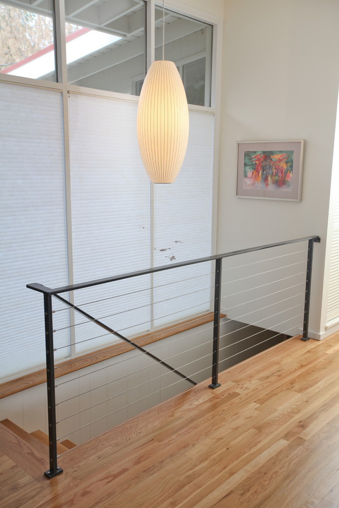 Inspiration for a small midcentury wood straight staircase in Seattle with wood risers.