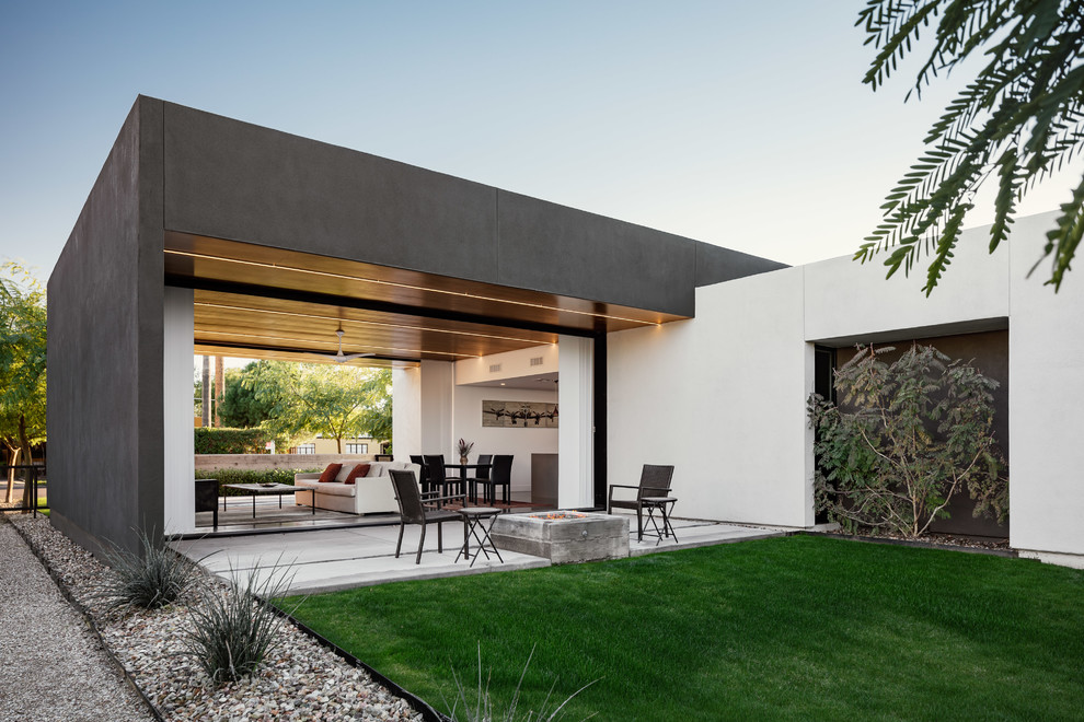 Photo of a modern backyard patio in Phoenix with a fire feature, concrete slab and no cover.