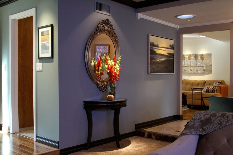 Inspiration for a mid-sized transitional travertine floor and beige floor hallway remodel in Orange County with purple walls
