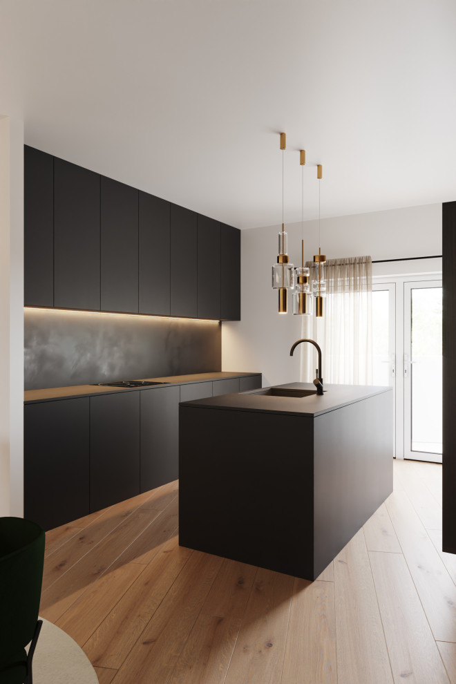 Inspiration for a modern single-wall open plan kitchen in Brussels with an integrated sink, beaded inset cabinets, black cabinets, black splashback, slate splashback, medium hardwood floors, with island and black benchtop.