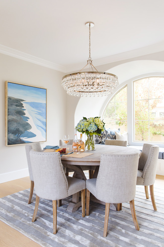 Design ideas for a mid-sized beach style open plan dining in San Diego with white walls, light hardwood floors, no fireplace and beige floor.