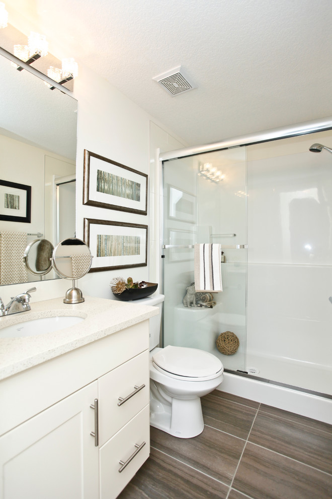 Inspiration for a contemporary bathroom in Calgary with an undermount sink, shaker cabinets, beige cabinets, engineered quartz benchtops, gray tile, porcelain tile and white walls.