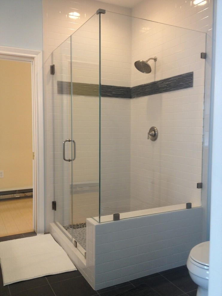 Photo of a mid-sized traditional bathroom in New York with a corner shower, subway tile and blue walls.