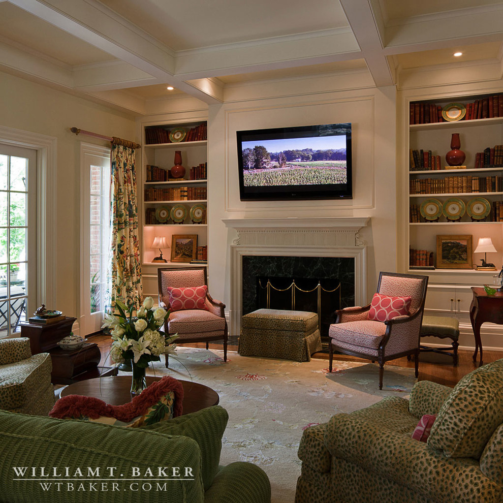 Design ideas for a large traditional enclosed family room in Atlanta with beige walls, dark hardwood floors, a standard fireplace, a wood fireplace surround and a wall-mounted tv.