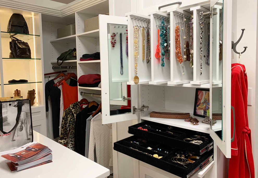 Design ideas for a contemporary walk-in wardrobe for women in Philadelphia with shaker cabinets and white cabinets.