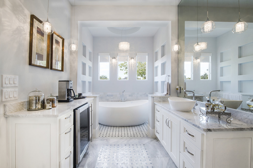 Inspiration for a transitional bathroom in Austin with a vessel sink, recessed-panel cabinets, white cabinets, a freestanding tub and grey walls.