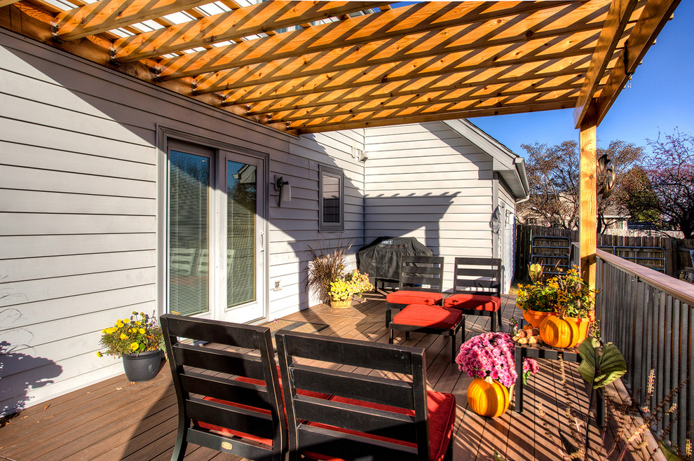 Example of a mid-sized transitional backyard deck design with a pergola