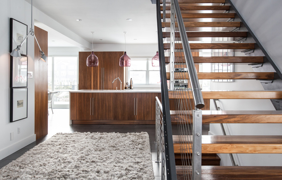 Contemporary staircase in Other with cable railing.