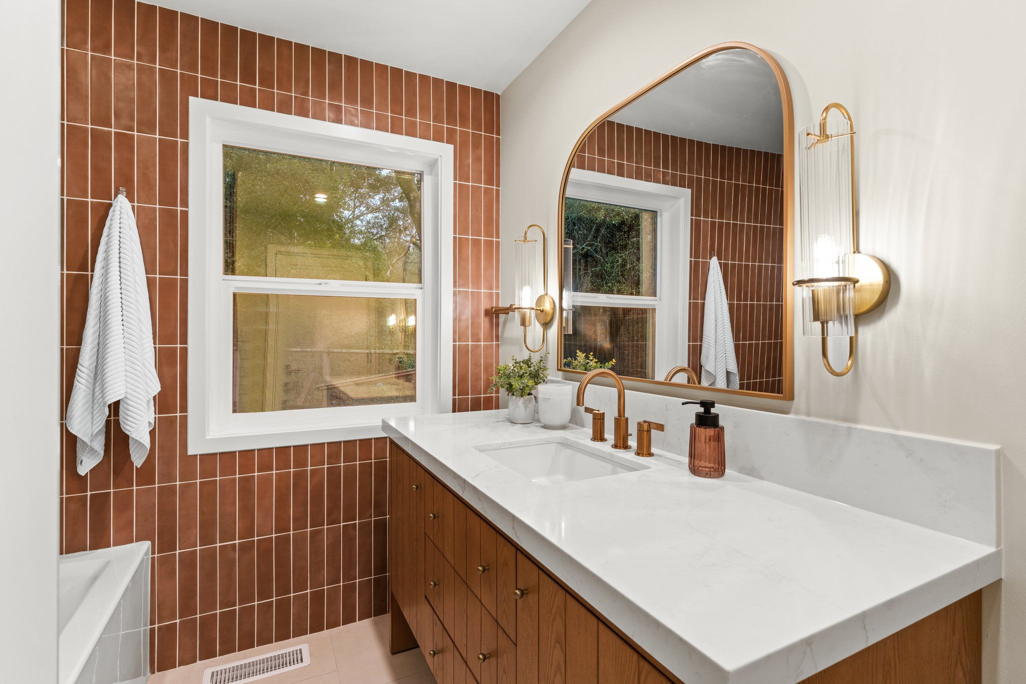 Mid-sized transitional trendy orange ceramic porcelain tile, marbled counter with single-sink bathroom photo with light wood cabinets, and modern mirror and fixtures.