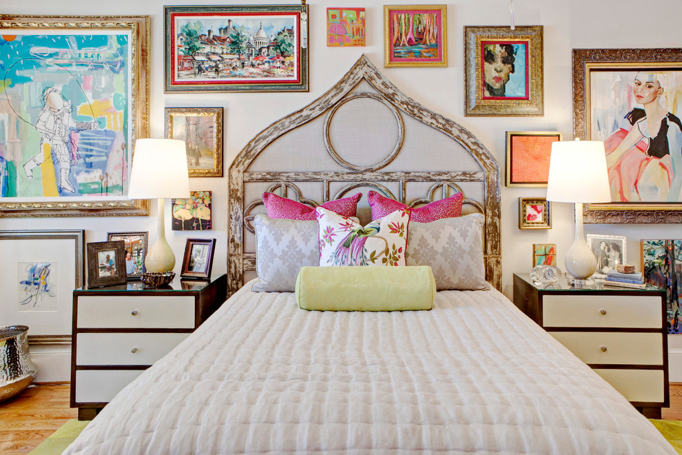 This is an example of a large eclectic master bedroom in Other with beige walls and medium hardwood floors.