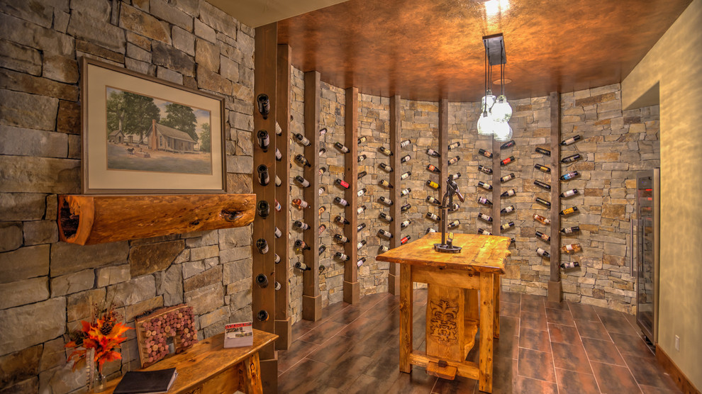 This is an example of a large traditional wine cellar in Denver with display racks, porcelain floors and red floor.