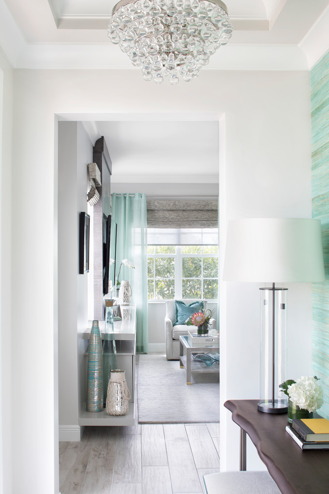 Photo of a mid-sized beach style foyer in Miami with white walls, porcelain floors, a single front door, a white front door and grey floor.