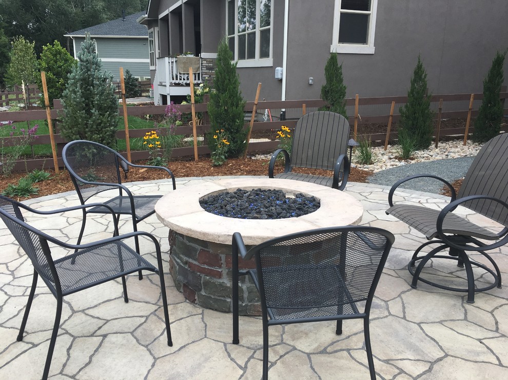 Photo of a traditional patio in Denver with a fire feature and natural stone paving.