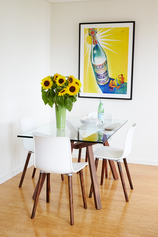 Photo of a mid-sized contemporary dining room in Sydney with white walls and light hardwood floors.