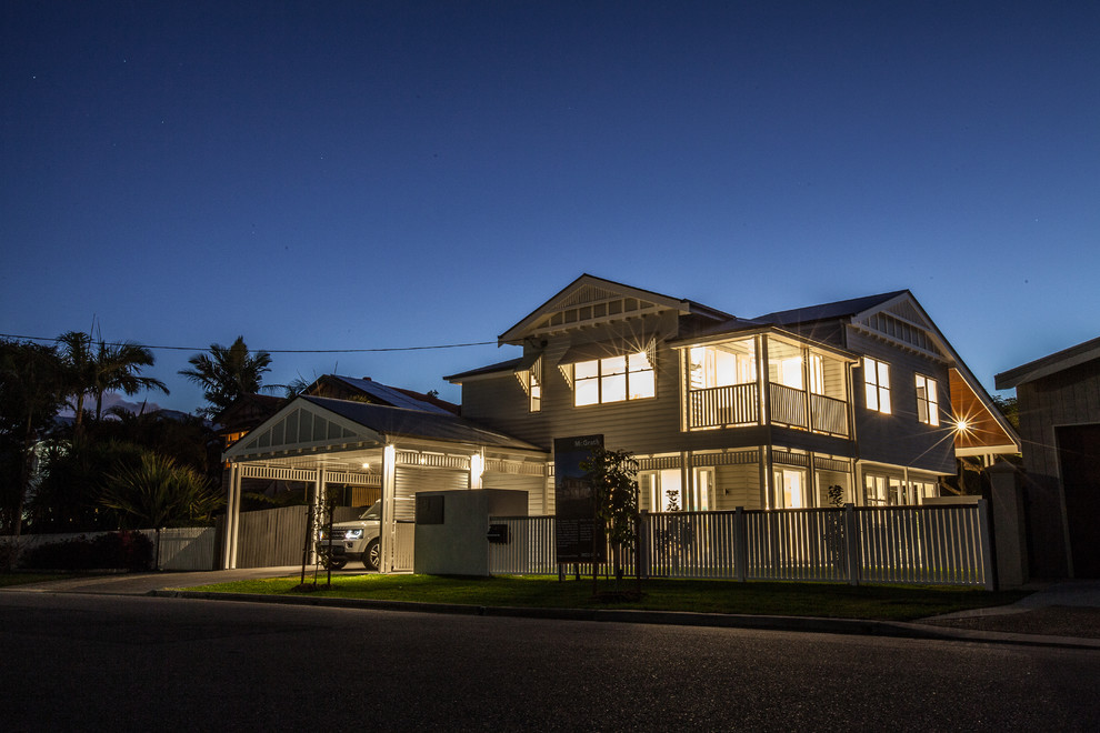 Large traditional two-storey grey house exterior in Brisbane with concrete fiberboard siding, a gable roof and a metal roof.
