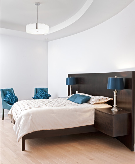 Design ideas for a mid-sized contemporary master bedroom in Ottawa with white walls and light hardwood floors.
