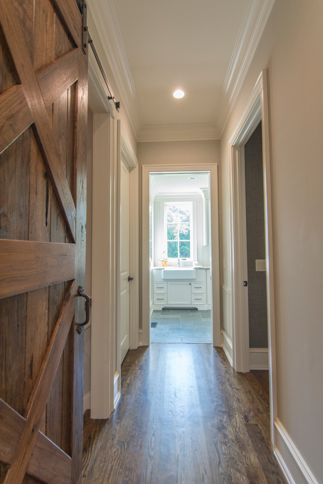 Mid-sized eclectic hallway in Raleigh with beige walls, dark hardwood floors and brown floor.