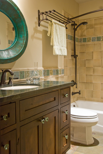 This is an example of a mid-sized traditional kids bathroom in Denver with a drop-in sink, recessed-panel cabinets, dark wood cabinets, granite benchtops, an alcove tub, a shower/bathtub combo, a one-piece toilet, beige tile, ceramic tile, beige walls and ceramic floors.