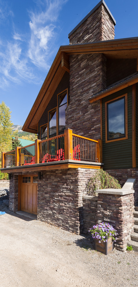 Inspiration for a mid-sized country two-storey green exterior in Calgary with wood siding and a gable roof.