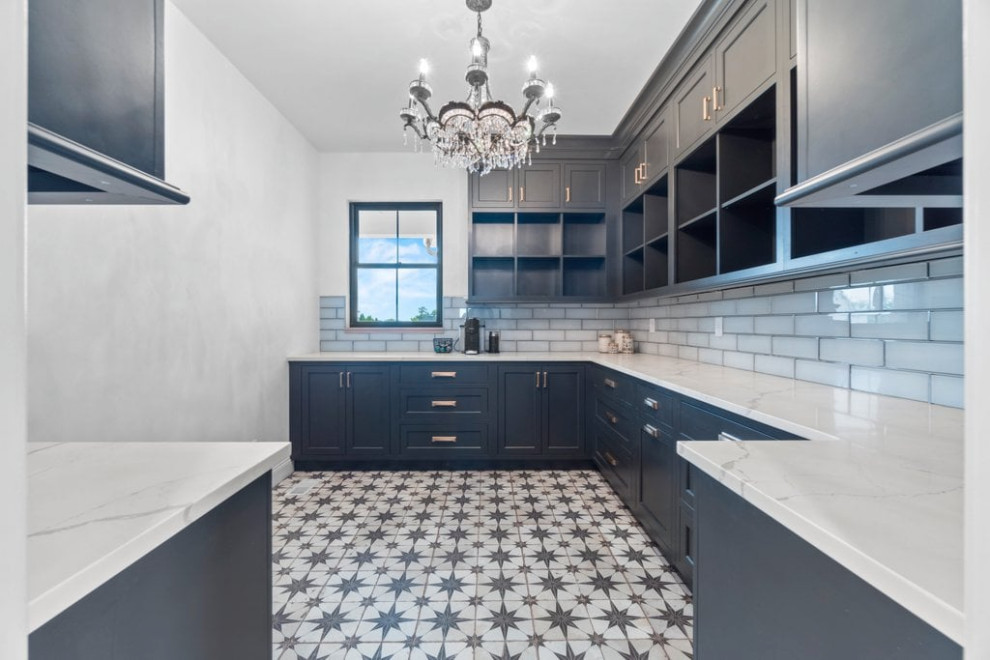 Inspiration for a large country l-shaped kitchen pantry in St Louis with recessed-panel cabinets, blue cabinets, quartzite benchtops, white splashback, subway tile splashback, ceramic floors, white floor and white benchtop.