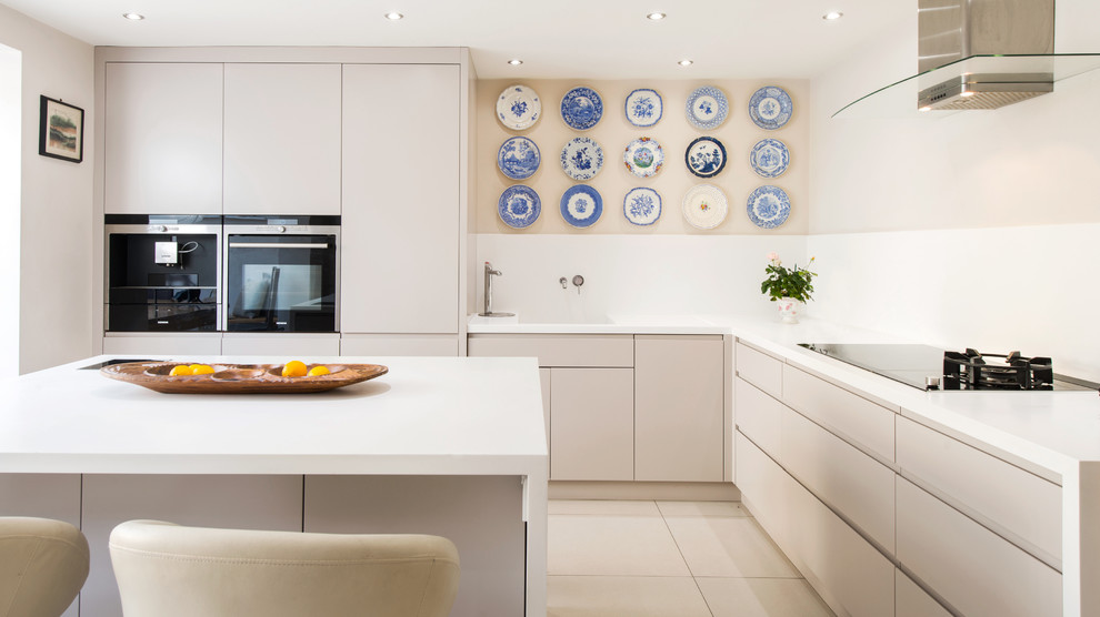 Inspiration for a large contemporary galley eat-in kitchen in London with ceramic floors, with island, flat-panel cabinets and white cabinets.