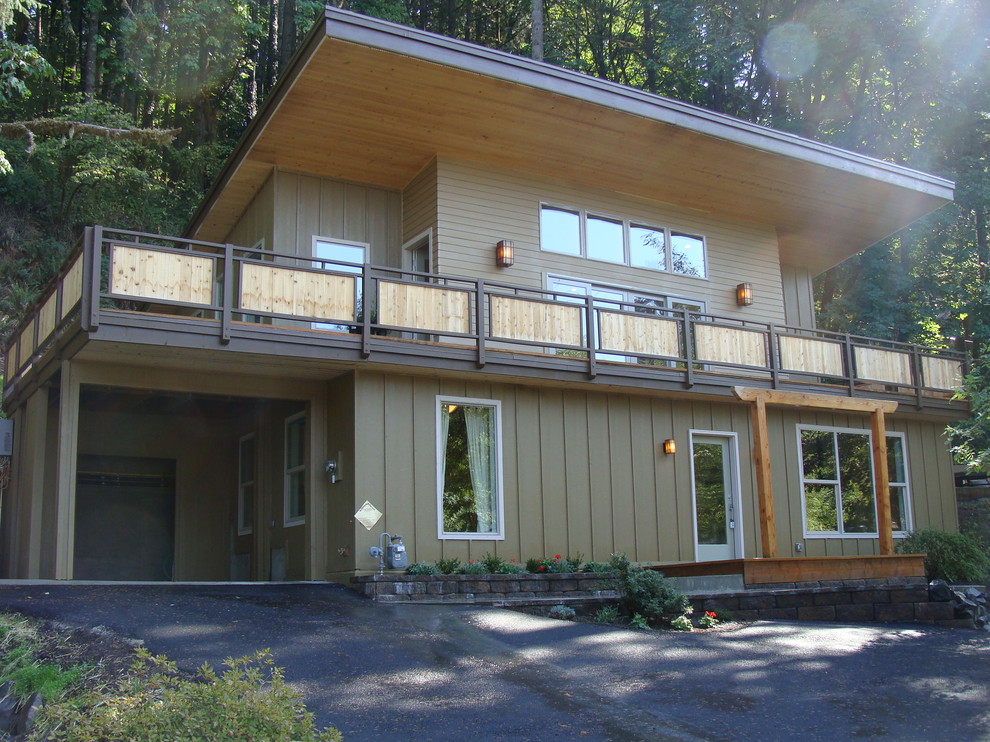 Mid-sized asian two-storey brown exterior in Other with wood siding and a shed roof.