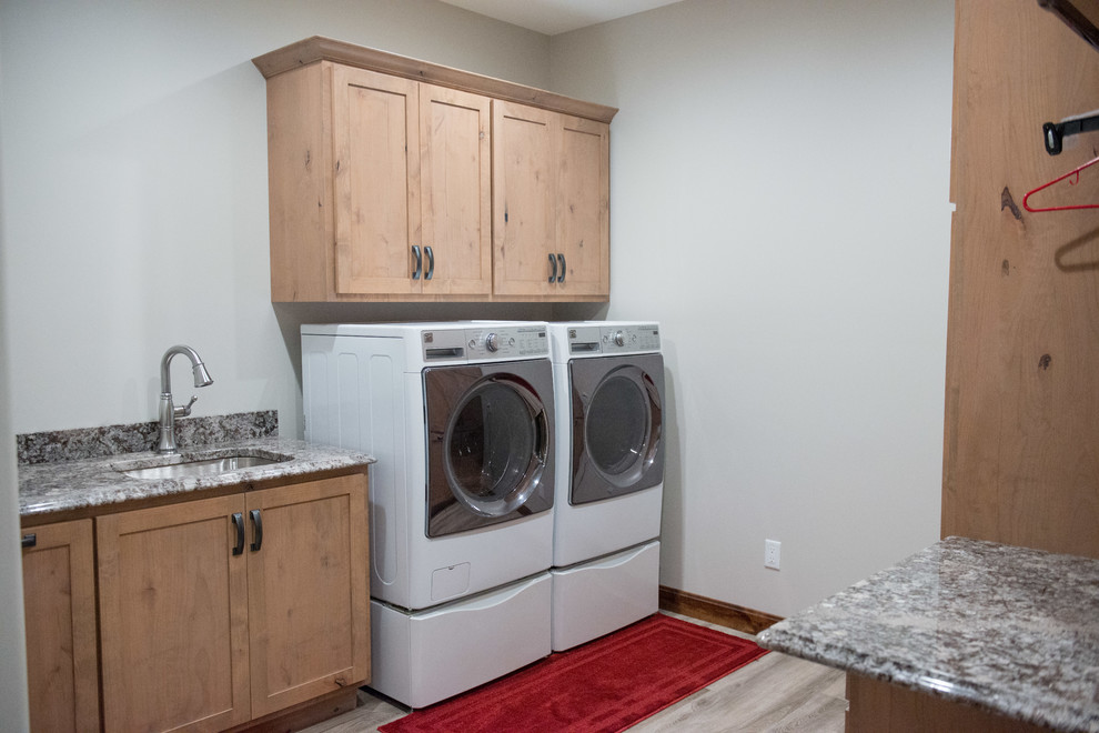 Utility room - large rustic u-shaped laminate floor utility room idea with an undermount sink, shaker cabinets, light wood cabinets, granite countertops, white walls, a side-by-side washer/dryer and multicolored countertops