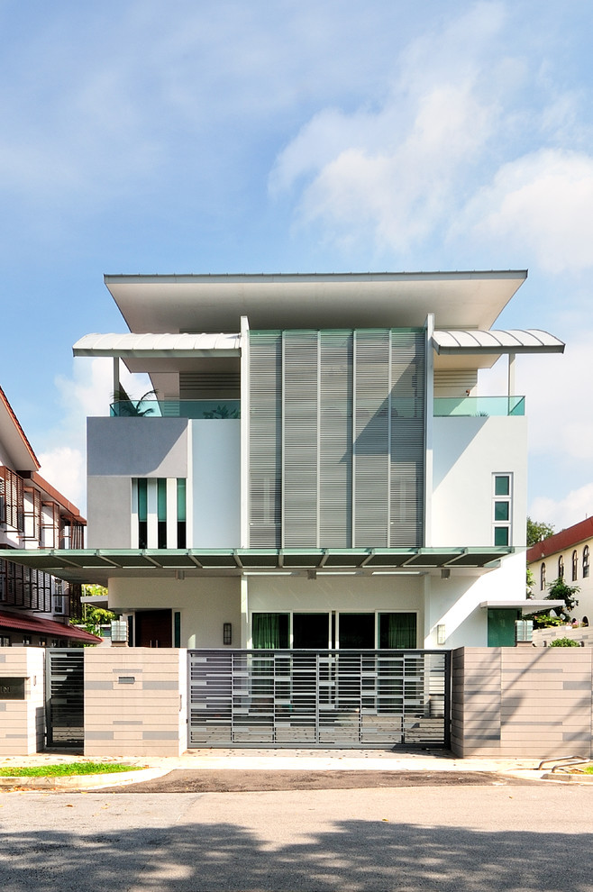 Contemporary three-storey white exterior in Singapore with mixed siding.