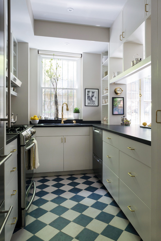 Design ideas for a small transitional galley separate kitchen in New York with an undermount sink, glass-front cabinets, white cabinets, soapstone benchtops, white splashback, porcelain splashback, stainless steel appliances, porcelain floors, no island and blue floor.